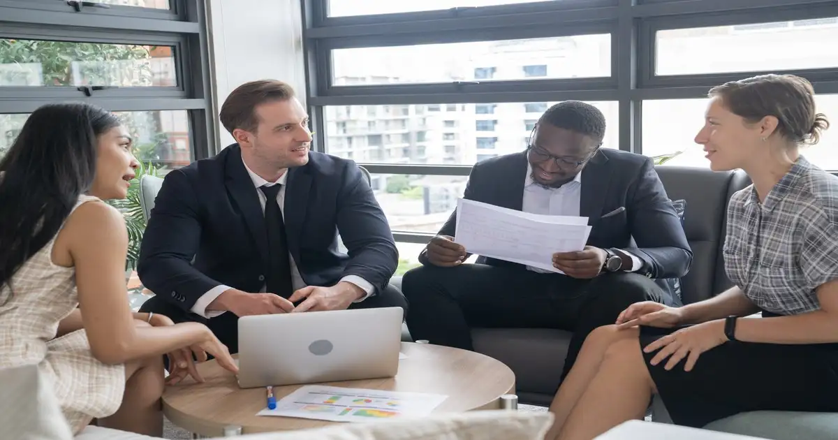 Equipe de negócios reunida discutindo estrutura de empresa LTDA em escritório
